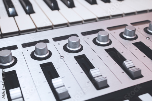 Close up MIDI Controller, keys  and feders photo