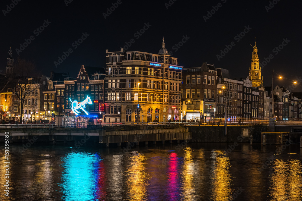 Night city view from railway station at Amsterdam Light Festival, The Netherlands