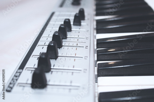 Close up MIDI Controller, keys  and feders photo