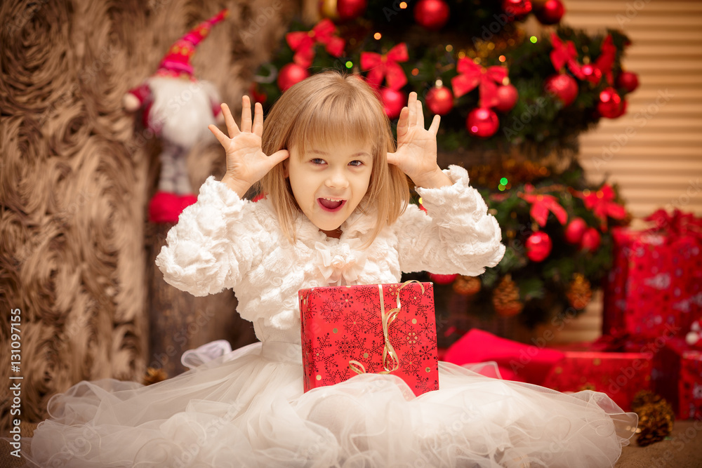 child holding a magic Christmas gift box child holding a magic Christmas gift box