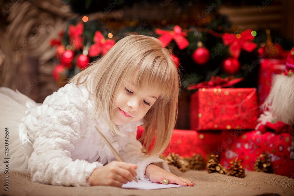 little girl writes a letter to Santa Claus