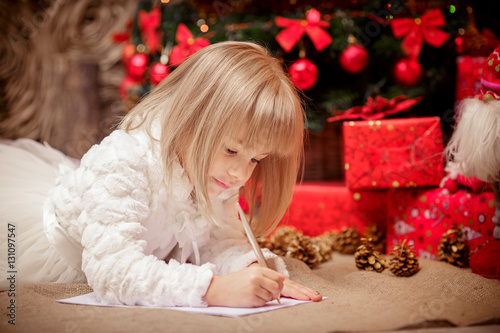 little girl writes a letter to Santa Claus