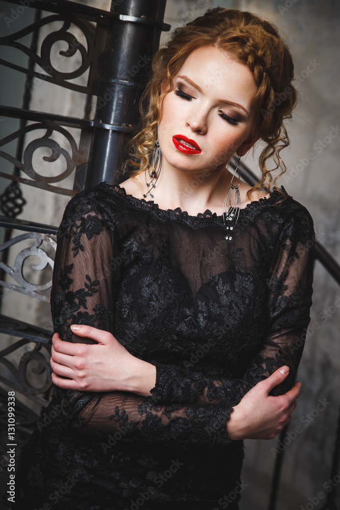sensual young lady in a black evening dress with naked back sensual young lady in a black evening dress with naked back