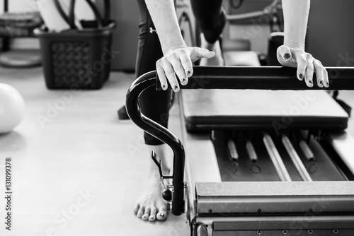Pilates reformer exercise's detail in black and white. photo