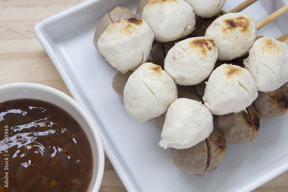 Pork meatballs on white plate placed on a wooden floor. Pork meatballs on white plate placed on a wooden floor.
