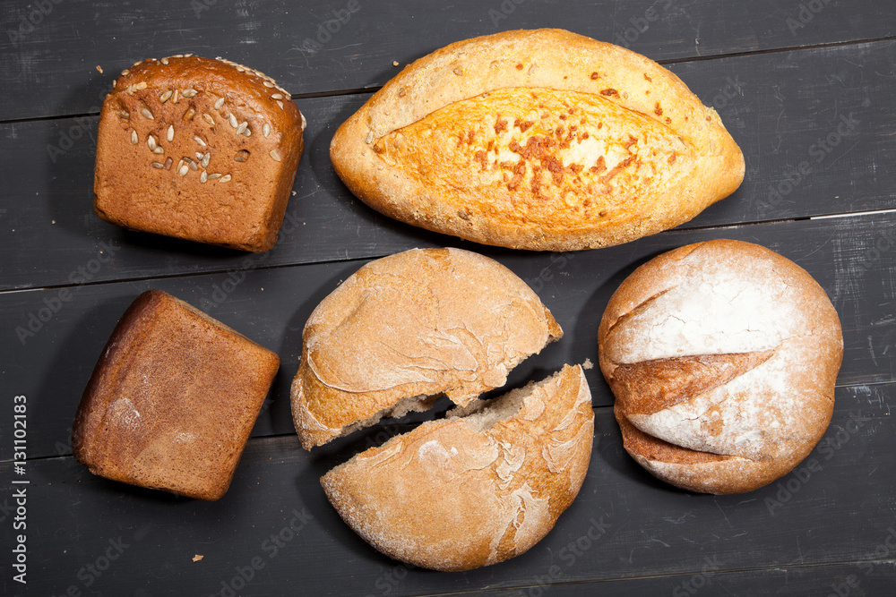 Homemade bread on a black wooden background Homemade bread on a black wooden background