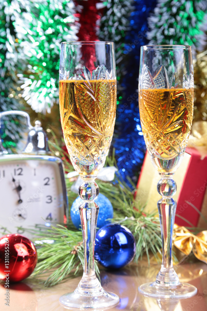 Glass of sparkling shampagne wine clock and gift box on christmas background Glass of sparkling shampagne wine clock and gift box on christmas background