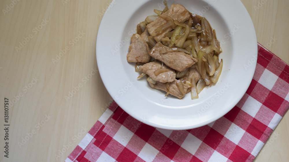 Delicious fried pork with onion prepared for breakfast