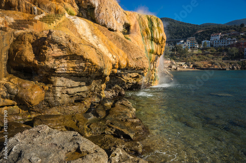 Scenic thermal waterfalls  on  beach in Loutro Edipsou, Evia, Gr photo