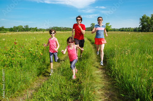 Family fitness outdoors, parents with kids jogging in park, running and healthy lifestyle 