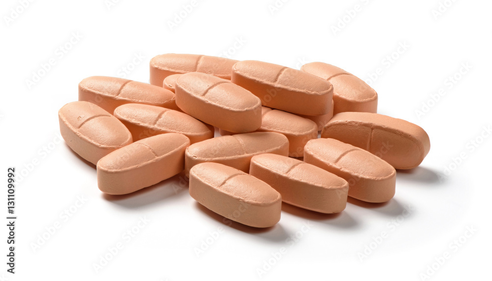 orange tablet pills on white background orange tablet pills on white background