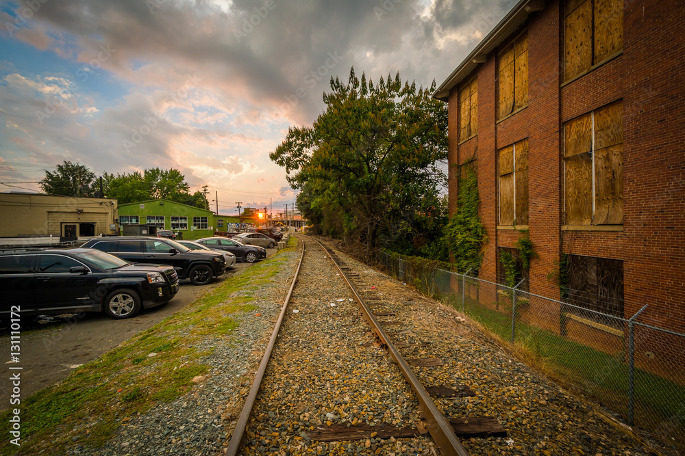 Fototapeta premium Railroad tracks and buildings, in NoDa, Charlotte, North Carolin