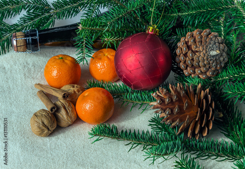 holiday concept: cones, tangerine, champagne bottle, spices and
