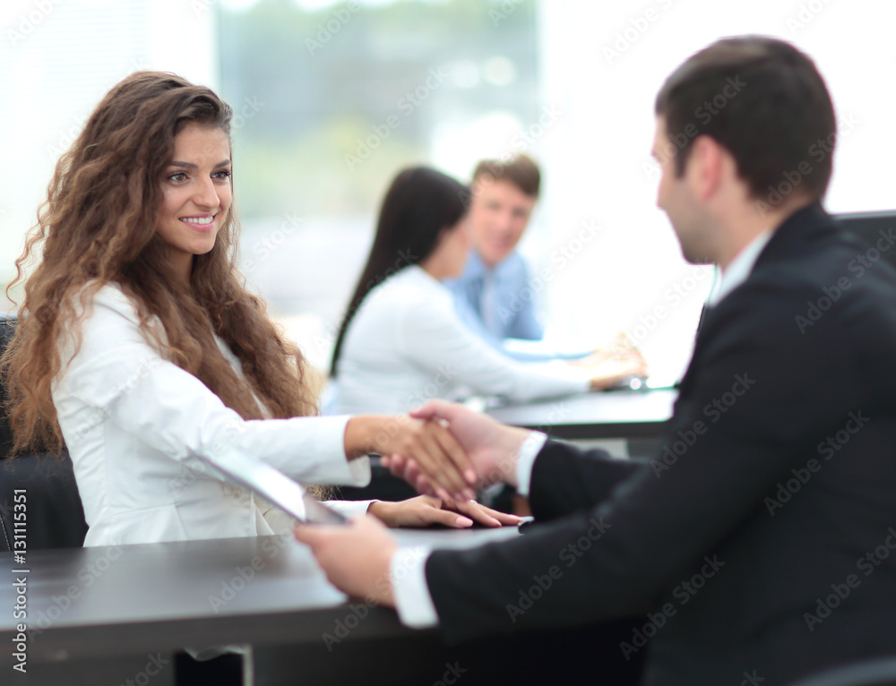 beautiful female Manager shaking hands with a client at the work beautiful female Manager shaking hands with a client at the work