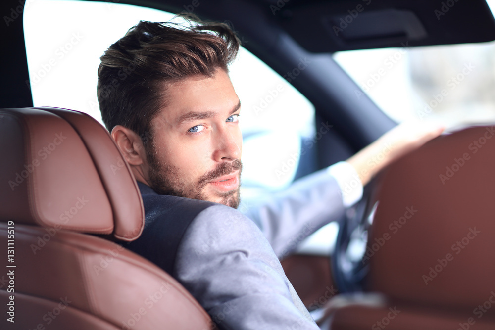 Portrait of an handsome smiling business man driving his car Portrait of an handsome smiling business man driving his car