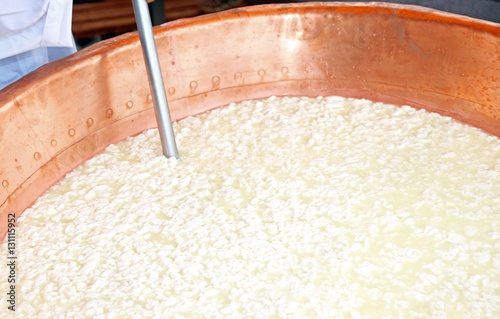 hot big copper cauldron with the curdled milk for the production photo