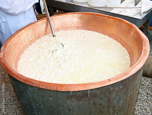 cauldron with sour milk and rennet to make cheese in the dairy photo