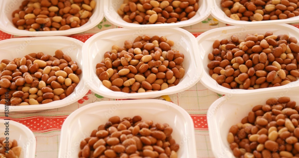 plastic plates with boiled beans during the party