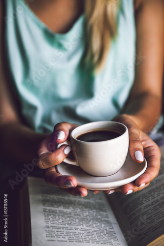 Girl with a cup of coffee and a book. Wakes up, morning, break,
