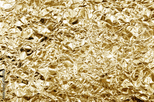 Shiny yellow gold golden color decorative texture paper. Alumini photo