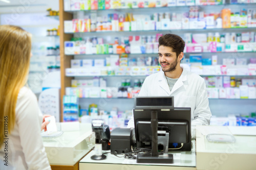 Experienced pharmacist counseling female customer in modern phar