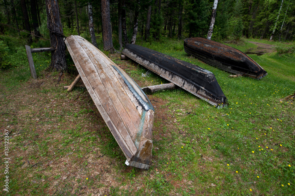 Fototapeta premium Three wooden upturned boats on the shore