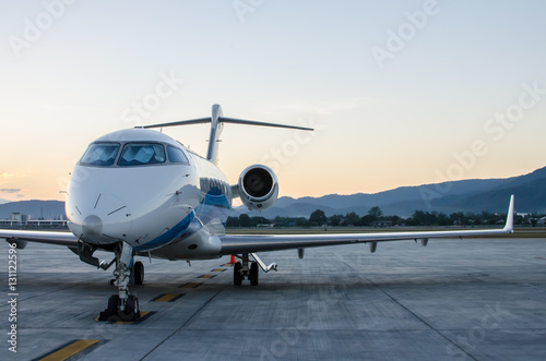 Small Airplane or Aeroplane Parked at Airport.Small Airplane Famous to use Private Airplane.Sunset Light and Mountain View. © migrean