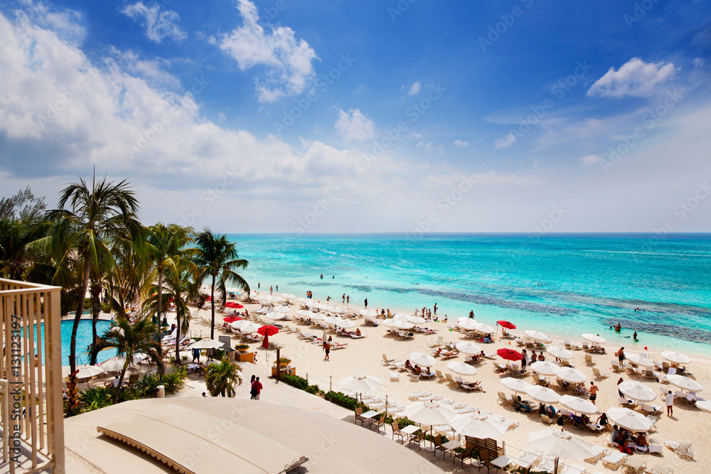 Vacationers enjoying the sun on Grand Cayman's Seven Mile Beach