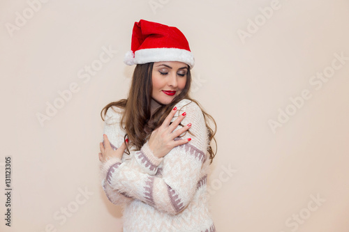 Portrait of a beautiful young woman  wearing Santa hat