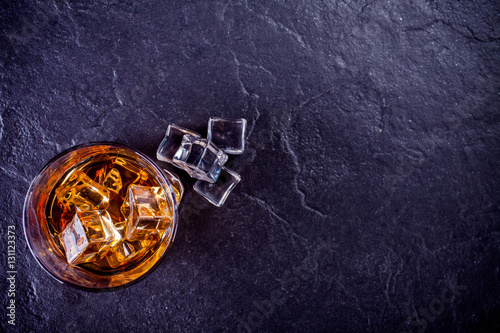 glass of whiskey with ice cubes