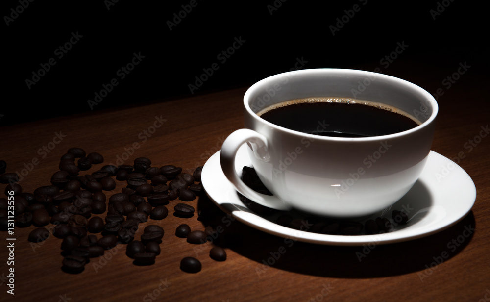 Obraz premium cup of coffee and beans on the table