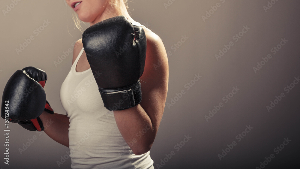 Naklejka premium Young woman arms wear boxing gloves.