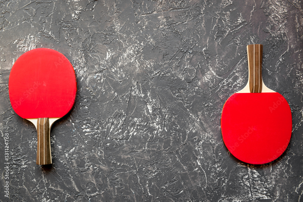 Red racket for ping pong ball gray background top view Red racket for ping pong ball gray background top view