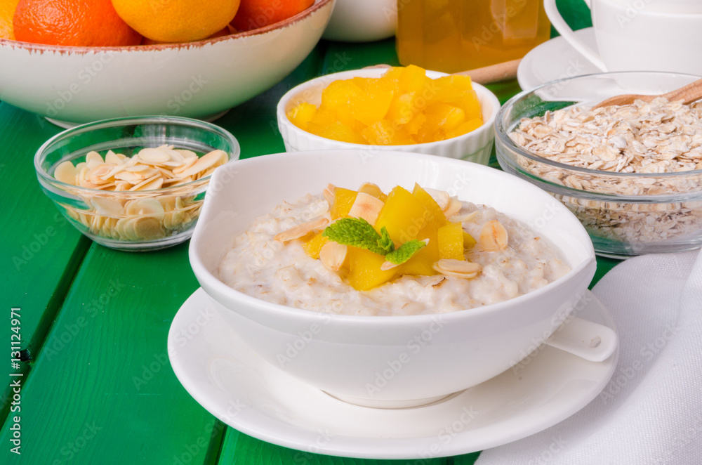 Oatmeal porridge with mango and almonds for breakfast Oatmeal porridge with mango and almonds for breakfast