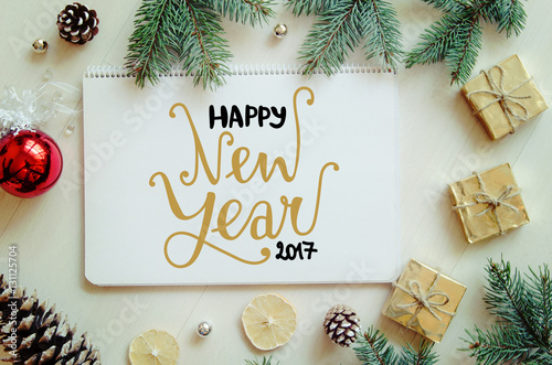 Christmas and New Year gifts, fir branches and pine cones flat lay background