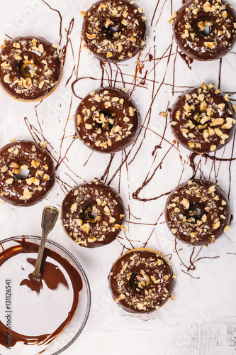 Fresh baked gluten free chocolate donuts and bowl with glaze