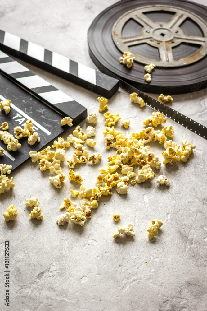 watching movie with popcorn on gray background close up watching movie with popcorn on gray background close up
