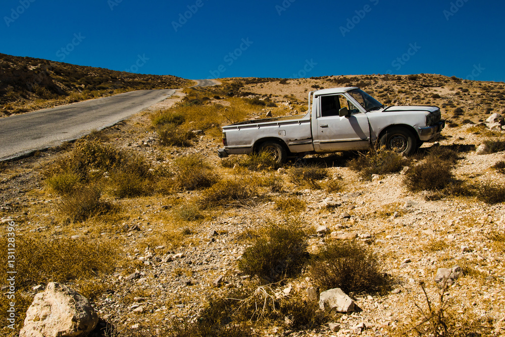 Old pickup truck on desert roadsid. Travel by car. Tourism and journey theme. Transportation, adventure concept. Summer holiday