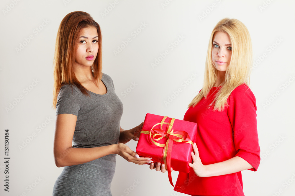 Two beautiful women with red gift box Two beautiful women with red gift box