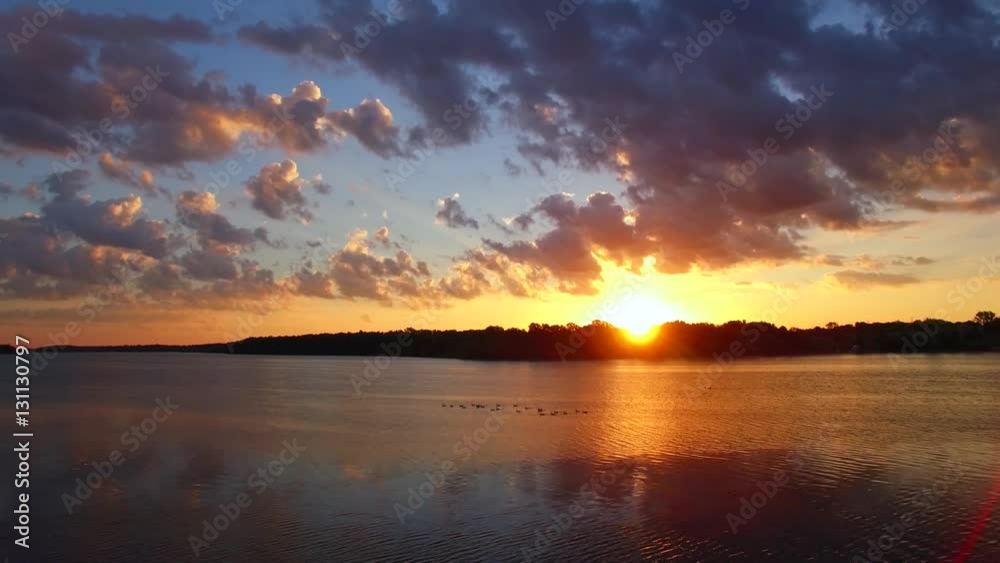 Amazingly colorful sunrise over vast river, drone aerial view.
Amazingly colorful sunrise over vast river, drone aerial view.