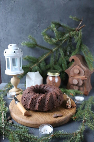 Chocolate cake with caramel and spices on rustic background for winter recreation. Christmas and New Year decorations