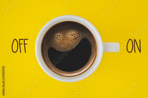 Cup of coffee on yellow background
