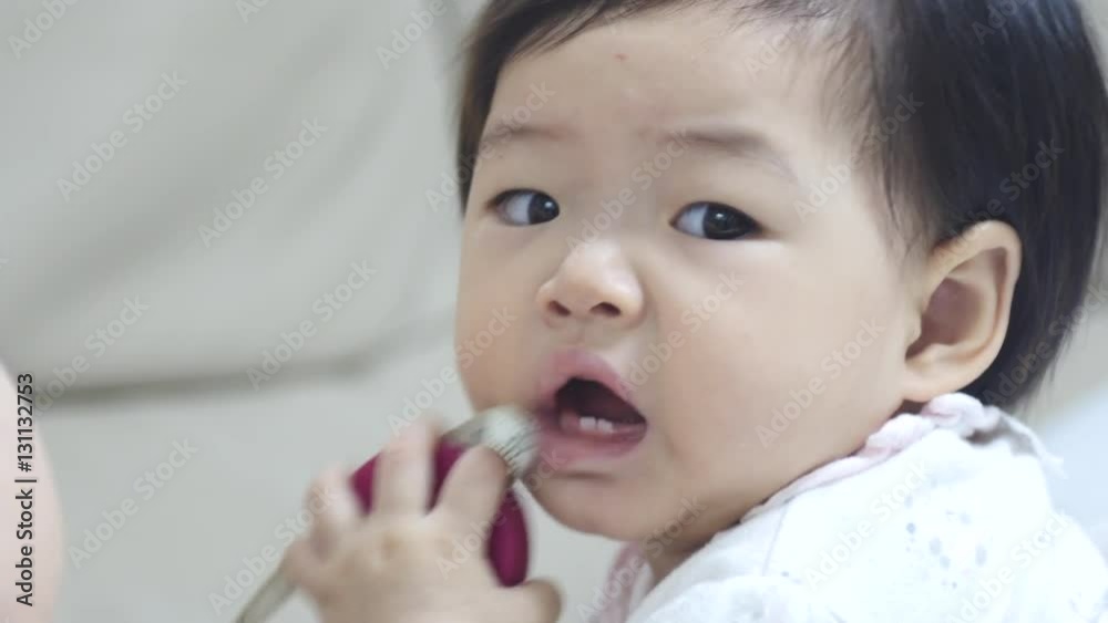 Cute Asian Baby Laughing And Showing Her First Teeth Closeup Cute Asian Baby Laughing And Showing Her First Teeth Closeup