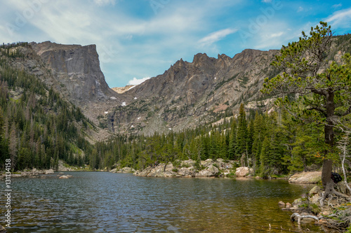 clear water and stone banks of Dream Lake surrounded by spruce forest with Hallett peak in the background Rocky Mountain National Park, Estes Park, Colorado, United States