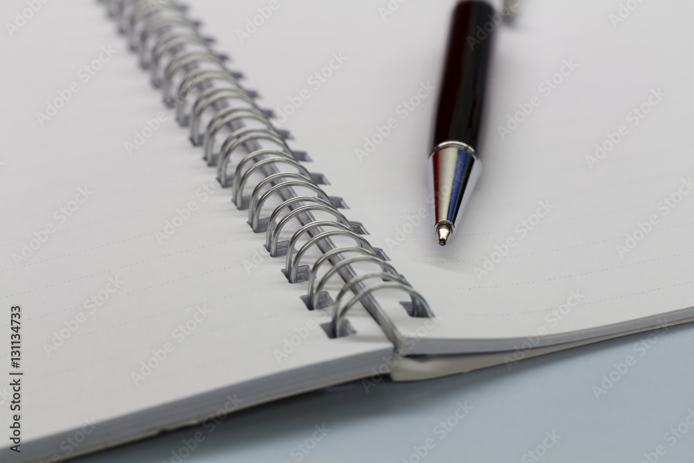 Black pen and notebook on the desk. Black pen and notebook on the desk.