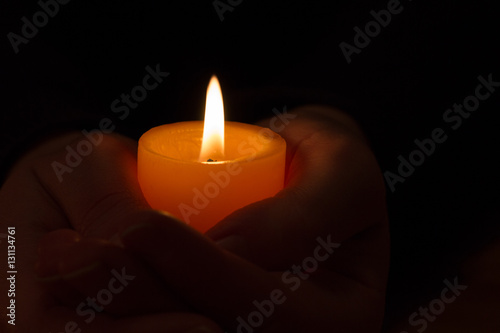 hands with orange candle