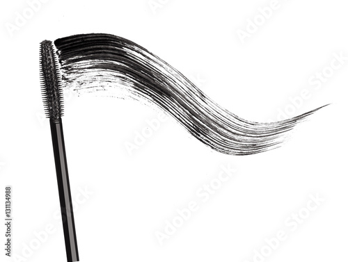Stroke of black mascara with applicator brush close-up, isolated photo