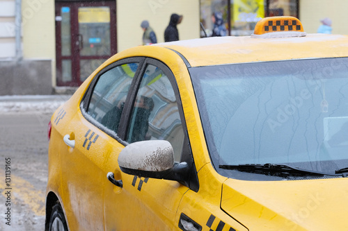 Moscow, Russia, December, 8, 2016: Close up image of .snow-covered Moscow yellow taxi