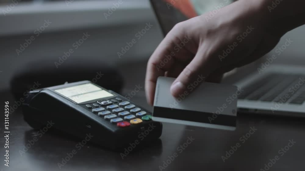 Man uses credit card terminal in the office. Close up shot. Concept of small business Man uses credit card terminal in the office. Close up shot. Concept of small business