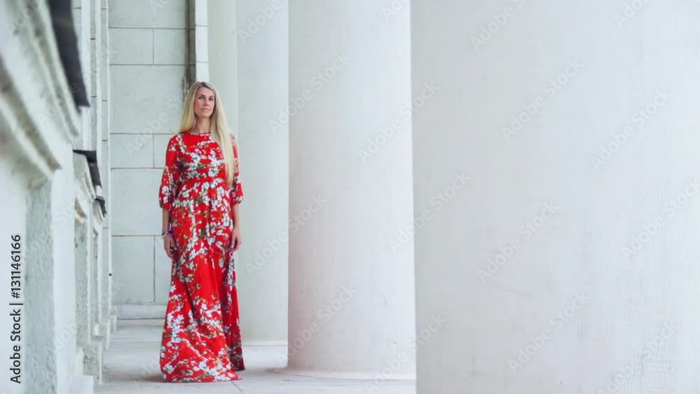 girl in a red dress for a walk in the city girl in a red dress for a walk in the city